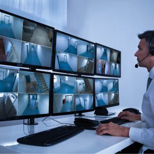 Security expert looking over video monitoring surveillance