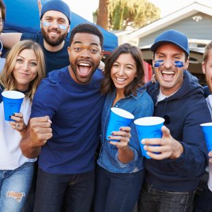 A team photo showing people cheering on a team in matching colors