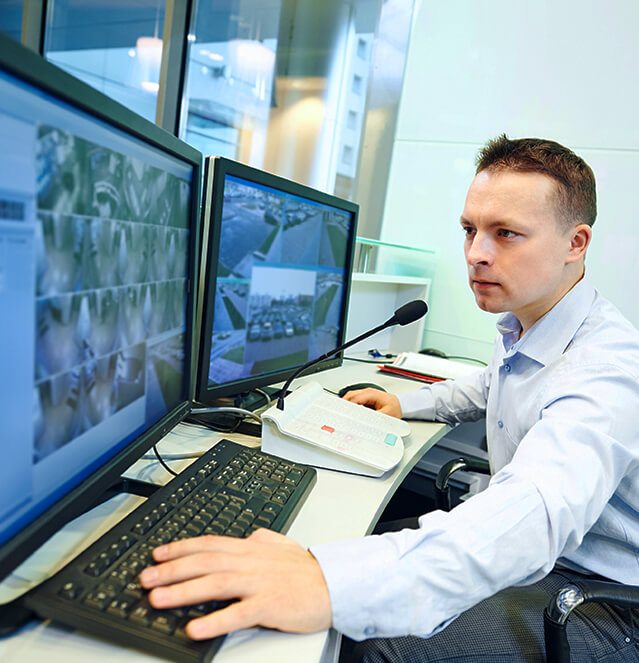 Security expert looking over video monitoring surveillance